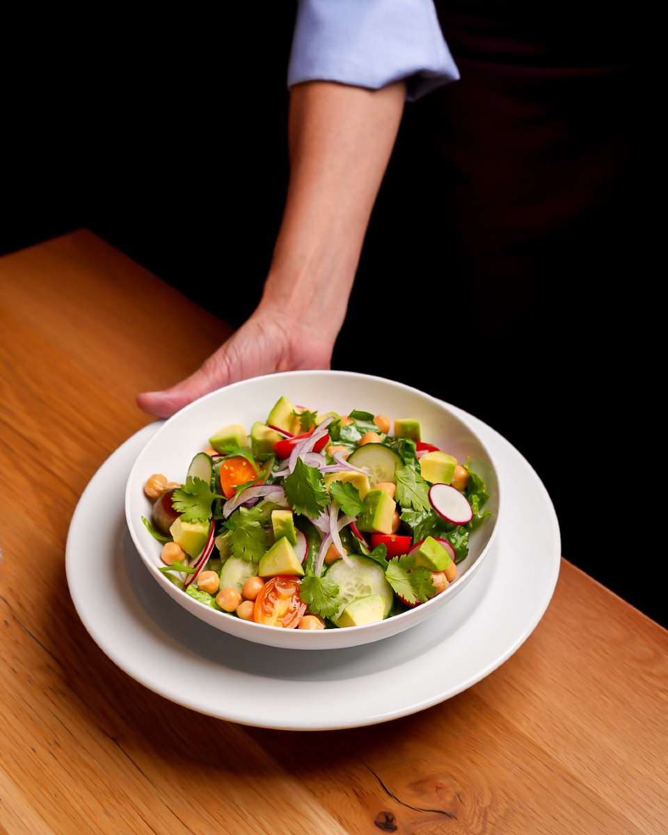 A salad that hits all the right notes — crisp cucumber, creamy avocado, hearty chickpeas, and juicy tomatoes over fresh romaine, all tied together with a bright lemon-sesame dressing 🥑
