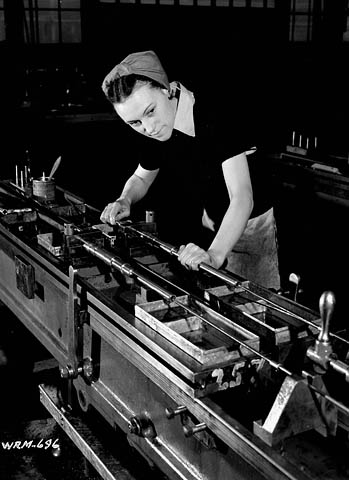 Woman adjusts machine boring barrels for Bren guns. John Inglis Bren Plant in Toronto, Ontario.

April 8, 1941. National Film Board.