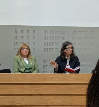 Frances Black sitting beside Francesca as she spoke to the room