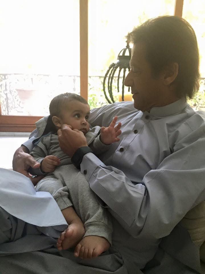 BeingSNK's tweet photo. Kaptaan Holding my Nieces Son Ahyl in Karachi.  
We miss you Kaptaan. #ReleaseImrankhansavePakistan https://t.co/jfHpV067JG