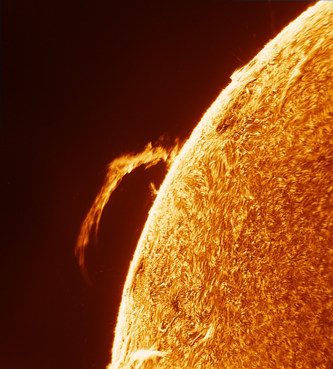 There is a *MASSIVE* arc of plasma on the sun right now. This is how it looked a moment ago, through a telescope I modified to see the sun's atmosphere. 

This arc is larger than Jupiter, and could fit dozens of Earths inside it.