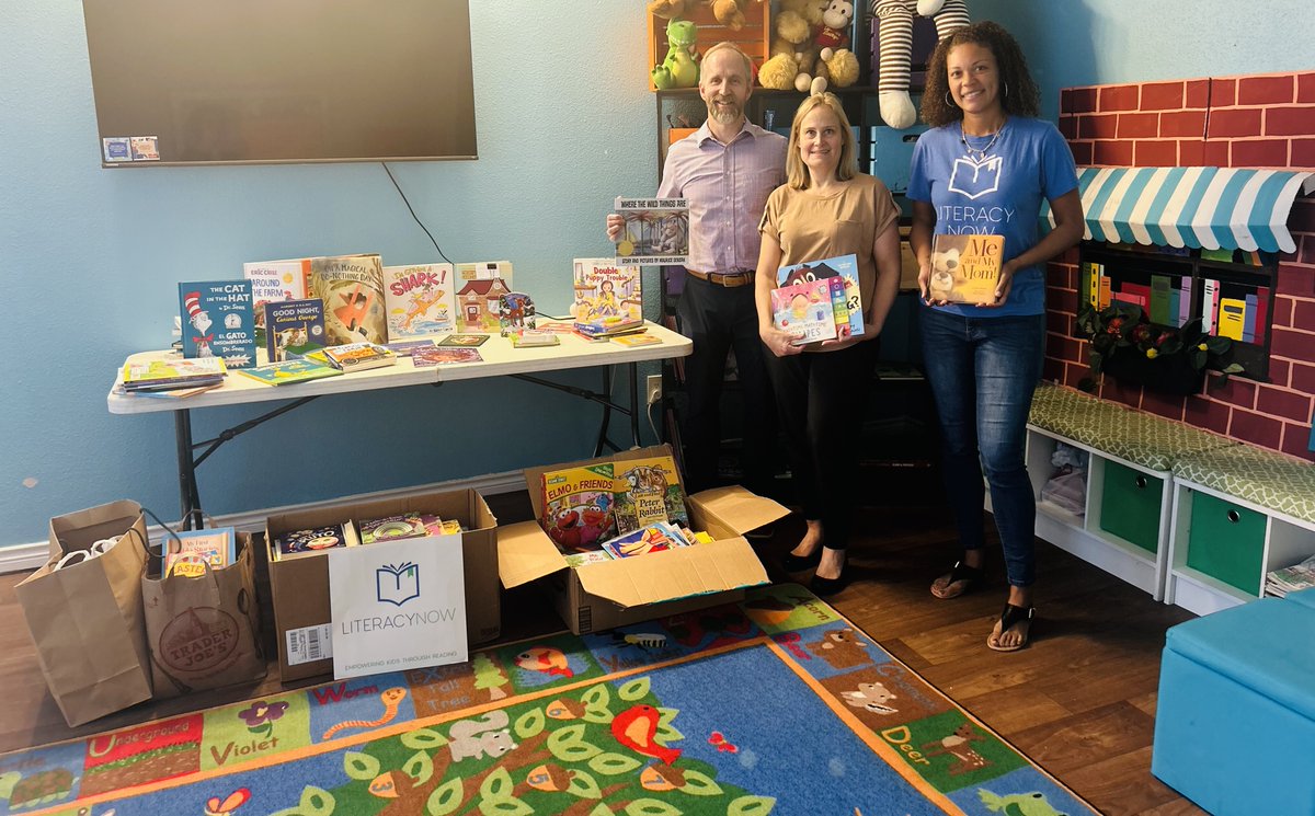 Thanks to our new friends at <a href="/JLL/">JLL</a> for their generous donations of over 225 books for our scholars! We are beyond grateful and look forward to continuing our partnership.  

Jones Lang LaSalle representatives, Mark Dennis and Jamie Lansaw, with Literacy Now's Precious Daniels.