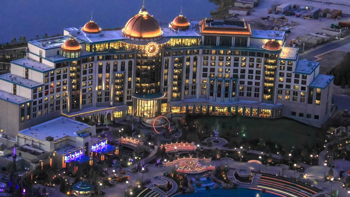 Aerial photo of Helios Grand Hotel at night. Top floor is Bar Helios, with a ballroom at right.