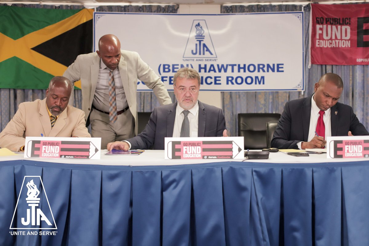 JTA collaborates EI to host the Jamaica Leg of the Go Public Fund Education Campaign,  Clayton Hall, JTA Ass. Sec. Gen. along with the current Head of the Administration, Dr. Mark Nicely (standing) and JTA President Dr. Mark Smith (far right)  Mr. Gavrielatos during the session.