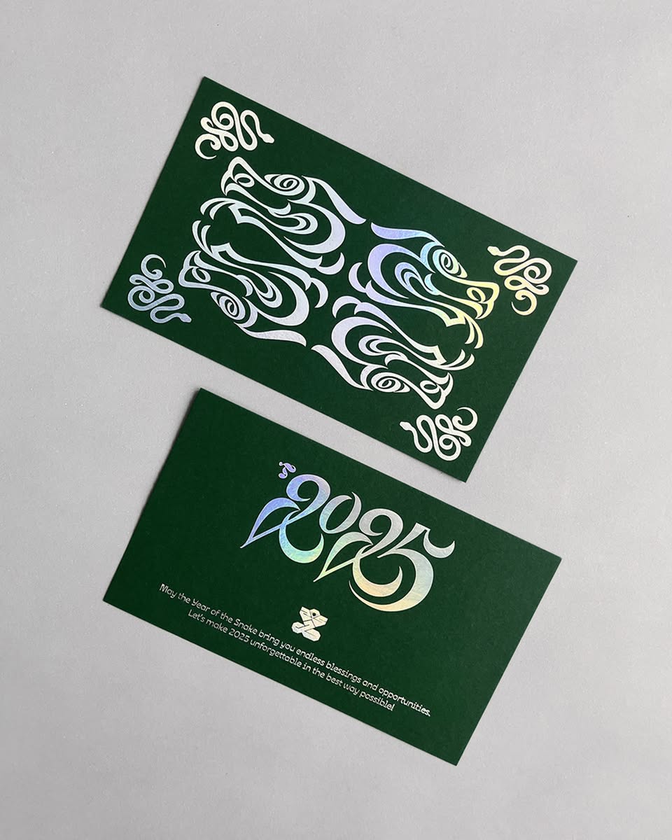 type_tanachat's tweet photo. Postcard design for the 'Year of the snake 2025', in which the designer has disguised the number 25 throughout the snake image.

Foil laser silver stamping was done on G.F Smith Colorplan Forest Green paper(270 gsm)

©2025 Type Tanachat
#postcarddesign #lettering #snakeyear2025 https://t.co/UBmaZggBTA