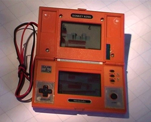 Yamapama's tweet photo. In 1982, CR44 batteries were too expensive for me as an 11 yo kid. So I modded my orange Donkey Kong Game &amp; Watch with the solar panel from an old calculator. It worked. I'd built the world’s first solar-powered handheld gameconsole.
 
#8Bit #RetroGaming #SolarHack https://t.co/OAqWmntE23