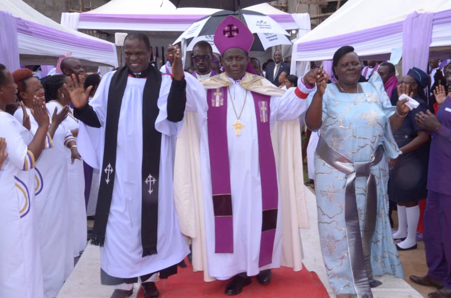 Namirembe Diocese (@bishopsvoice) on Twitter photo Bishop Moses Banja showing Ven. Captain Elly Wasswa and the wife to the congregation after their installation yesterday at Gayaza. <a href="/ChurchofUganda_/">Church of Uganda</a> <a href="/Archbp_COU/">Archbishop Stephen Kaziimba</a> <a href="/coufamilytv/">COU Family TV</a> <a href="/FathersUnion/">Fathers' Union-Church of Uganda</a> <a href="/NamirembeYouth/">Namirembe Diocese Youth Department</a> <a href="/Namirembefm939/">93.9 Namirembe Fm</a> <a href="/Online_COU/">Online Church of Uganda</a> <a href="/NdejjeUnive/">Ndejje University</a> <a href="/Mengo_School/">Mengo Senior School</a> <a href="/St_Johns_Chapel/">St John's Chapel Mengo</a> Bishop Moses Banja showing Ven. Captain Elly Wasswa and the wife to the congregation after their installation yesterday at Gayaza. <a href="/ChurchofUganda_/">Church of Uganda</a> <a href="/Archbp_COU/">Archbishop Stephen Kaziimba</a> <a href="/coufamilytv/">COU Family TV</a> <a href="/FathersUnion/">Fathers' Union-Church of Uganda</a> <a href="/NamirembeYouth/">Namirembe Diocese Youth Department</a> <a href="/Namirembefm939/">93.9 Namirembe Fm</a> <a href="/Online_COU/">Online Church of Uganda</a> <a href="/NdejjeUnive/">Ndejje University</a> <a href="/Mengo_School/">Mengo Senior School</a> <a href="/St_Johns_Chapel/">St John's Chapel Mengo</a>