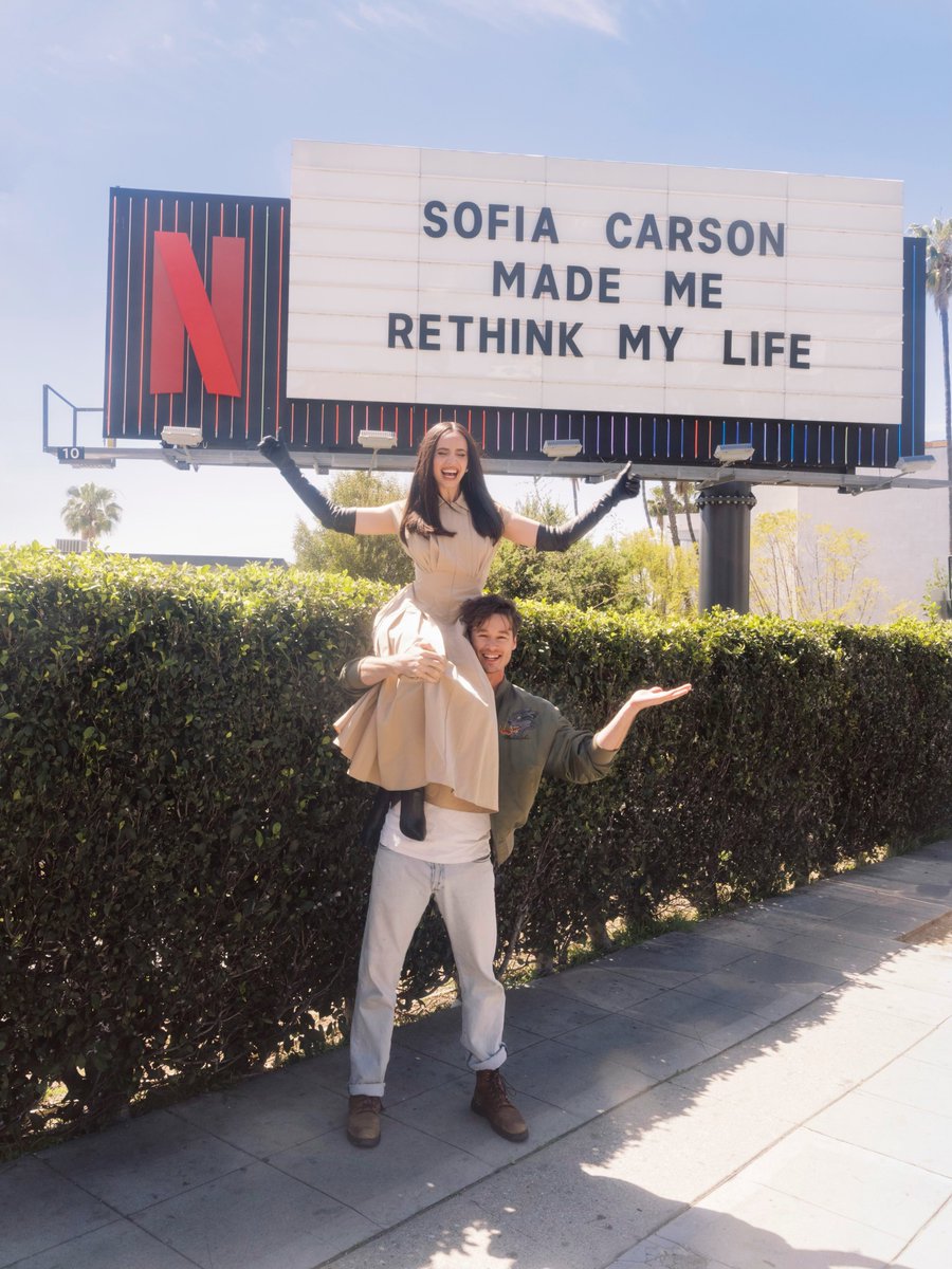 netflix's tweet image. Sofia Carson and Kyle Allen at The Life List marquee!