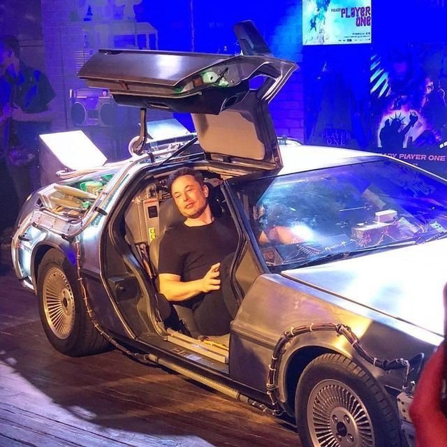 Elon Musk in the DeLorean car from Back to the Future movie.
