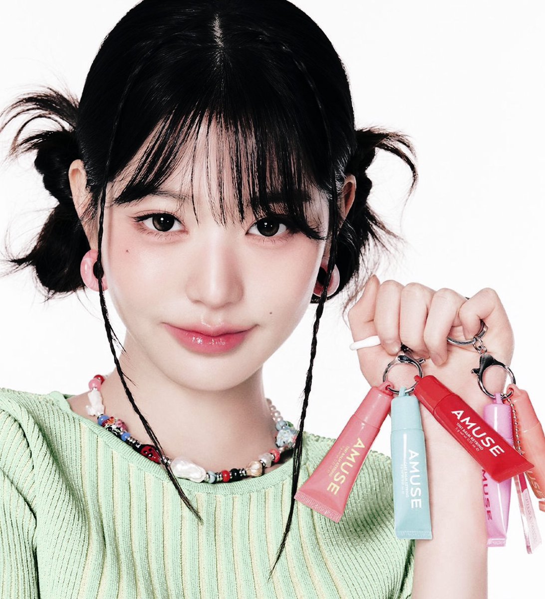 Draped   in   pastel   hues,   she’s   a  muse  of
youthful     wonder,     a     fleeting    vision   of
springtime's   gentle   sigh,   and   around  her 
neck,   beads  gleam,   each   one   whispering   tales of stolen  glances  and  secret  melodies