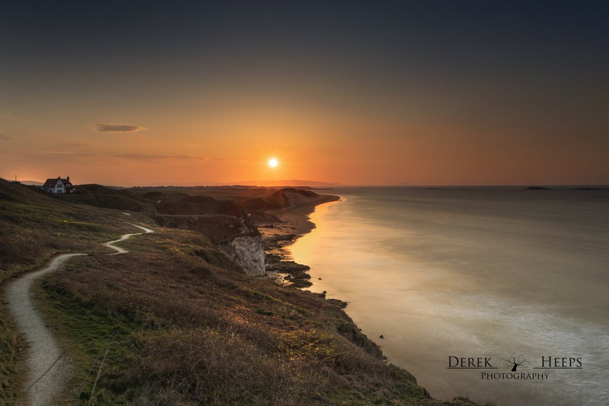 Whiterocks Beach , Portrush 

I went back on another visit to this location to see if I could get the setting sun closer to the end of the beach and was pleased with the results.

It was a lovely sunset and a pleasure to watch the sun slowly dip down at the end of the day.