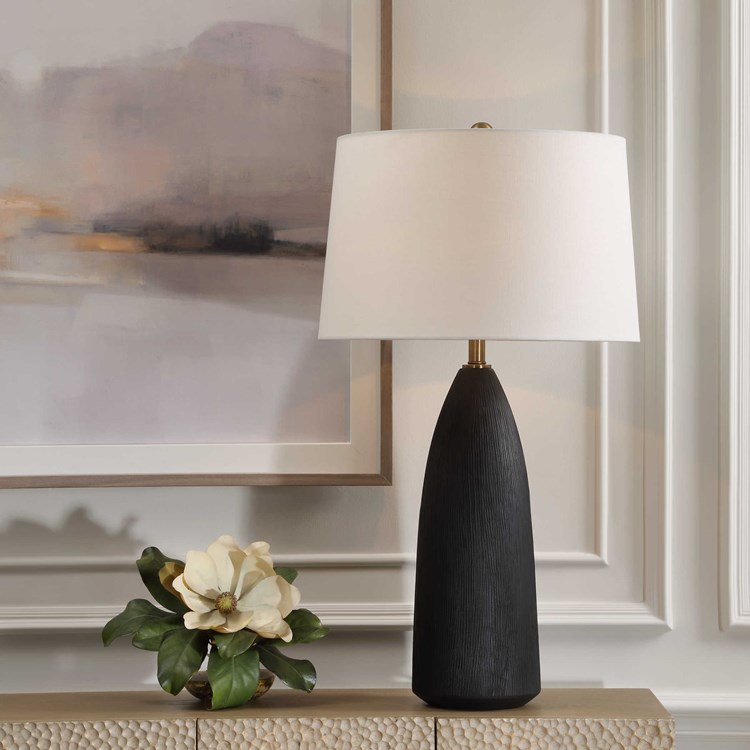 The Jett Table Lamp showcases a matte black ceramic base with organic texturing, accented with plated antique brass details. See it soon in the #uttermost showroom at #hpmkt. uttermost.com/jett-table-lam… #carolynkinder #interiordesign