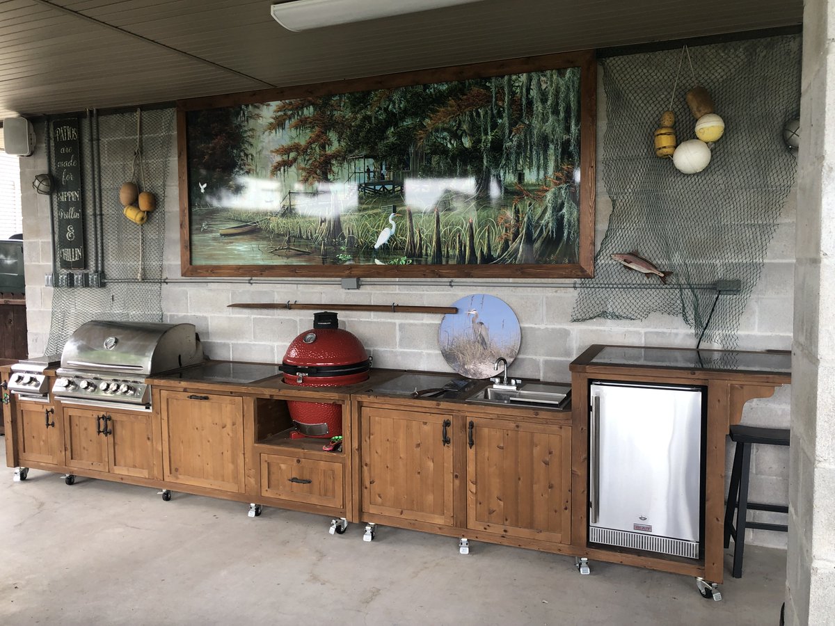Don't just cook outside, create a culinary oasis with a gas grill, kamado Joe smoker, and mini-fridge on covered patio. Elevate your outdoor cooking experience with the ultimate outdoor kitchen. #culinaryoasis #outdoorkitchen #grilling #OutdoorSanctuary #Louisiana