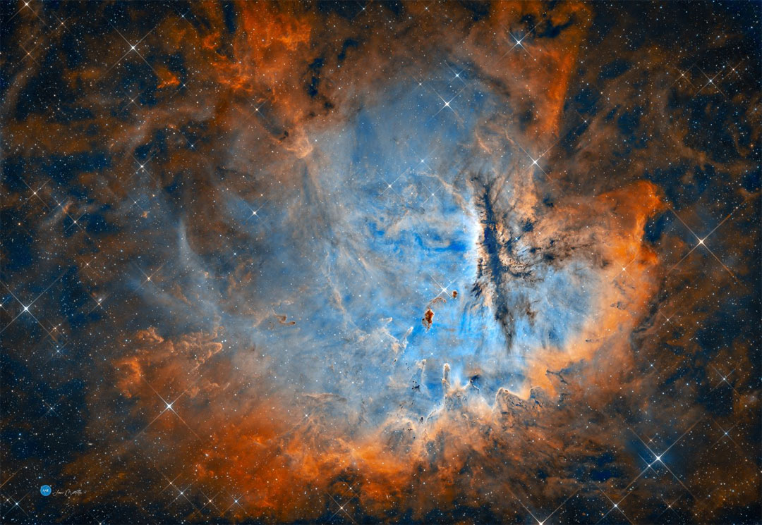 You'd think the Pacman Nebula would be eating stars, but actually it is forming them. Within the nebula, a cluster's young, massive stars are powering the pervasive nebular glow. The eye-catching shapes looming in the featured portrait of NGC 281 are sculpted dusty columns and
