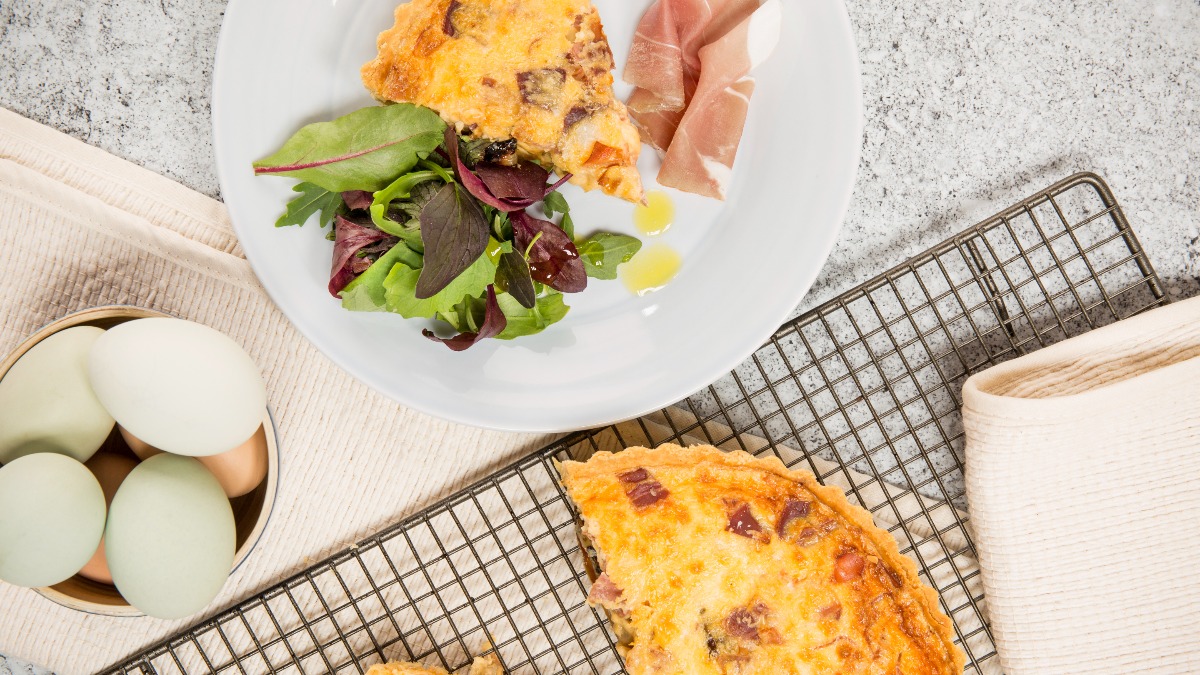 That delicate sliver of #ParmaHam nestled beside the quiche isn't just a garnish; it's a flavor enhancer! This pairing elevates a classic dish, adding a touch of Italian elegance.