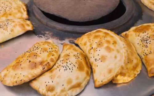 XinjiangTales's tweet photo. “Xinjiang’s Spring Obsession: Eating ‘Grass’ Never Tasted This Good！🥟  
Alfalfa-stuffed wontons? Crispy ‘green’ pancakes? Locals turn this weed into gourmet magic. PSA: Your salad game just got schooled. #SpringOnAPlate https://t.co/l6Mgm7pL3v