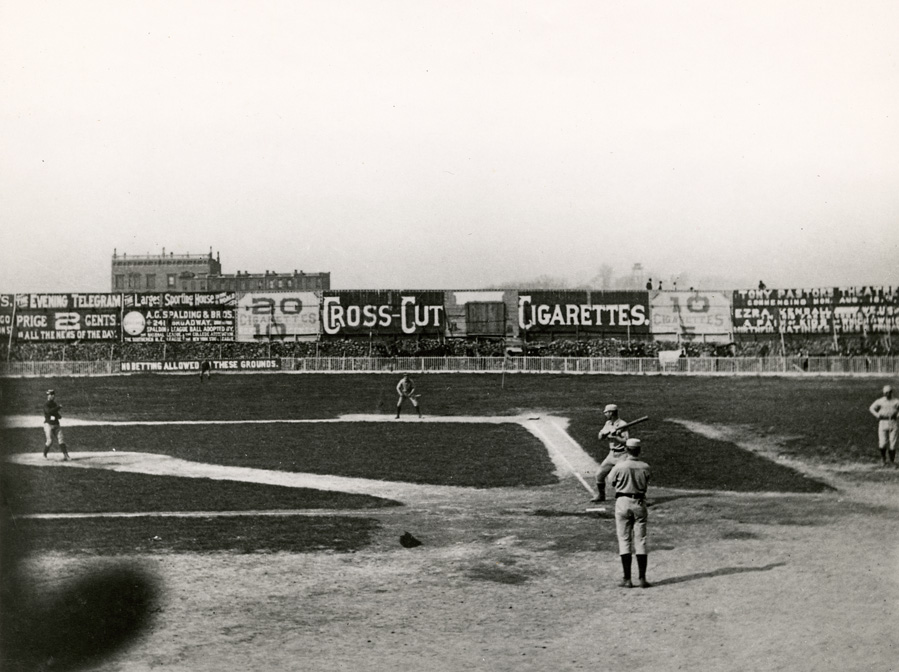 Opening Day at the original Polo Grounds, April 29, 1886. Hall of Famers Roger Connor batting, John Ward on deck, Buck Ewing throwing batting practice. Photo, one of several taken from grandstand by Richard Hoe Lawrence with a "detective camera."
