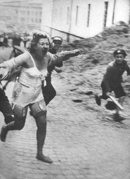 A Jewish woman was pursued by adults and young people carrying clubs during the 1941 pogroms in Lviv, Ukraine.