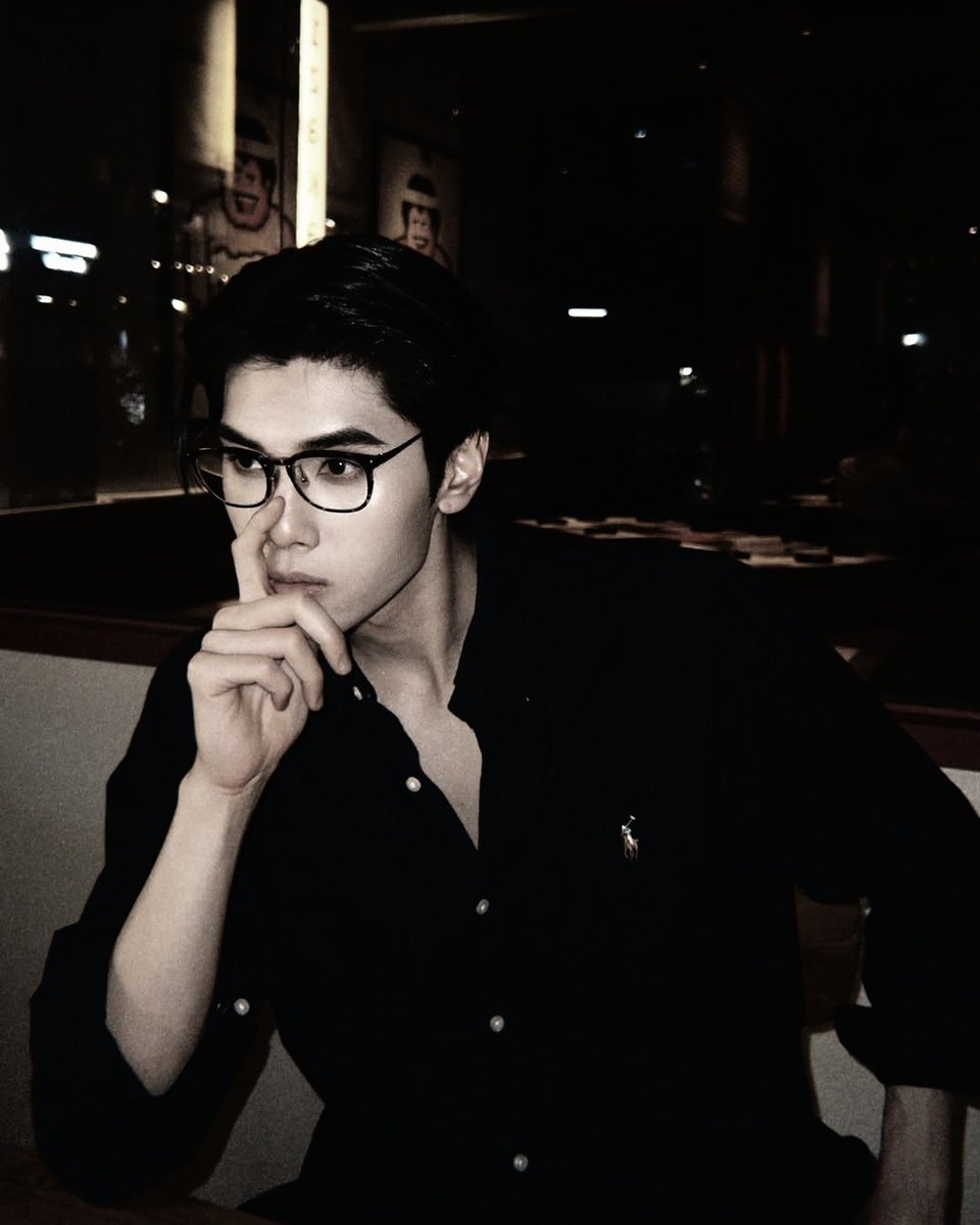 Looking effortlessly cool, even in a quiet moment. The perfect blend of style and mystery, captured in a frame.