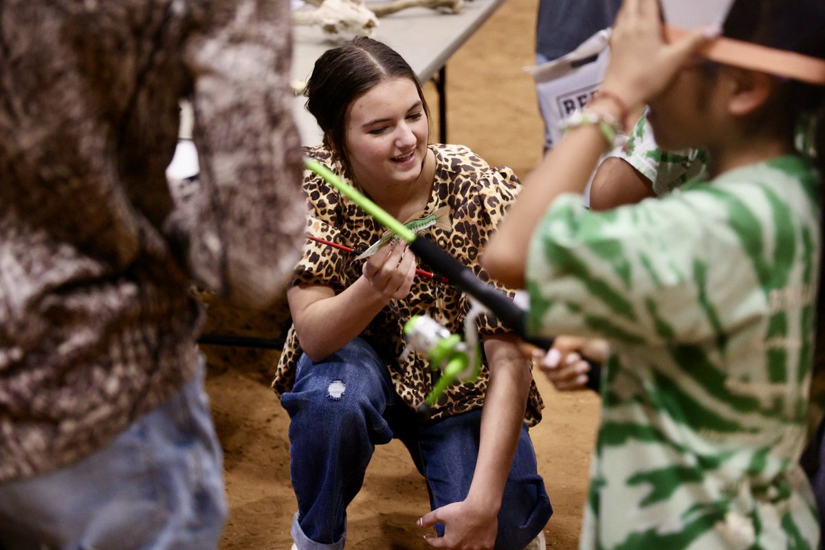 CSISD FFA students sharing their passion for agriculture with local elementary students at the Brazos County Youth Livestock Show Ag-You-Cate event.