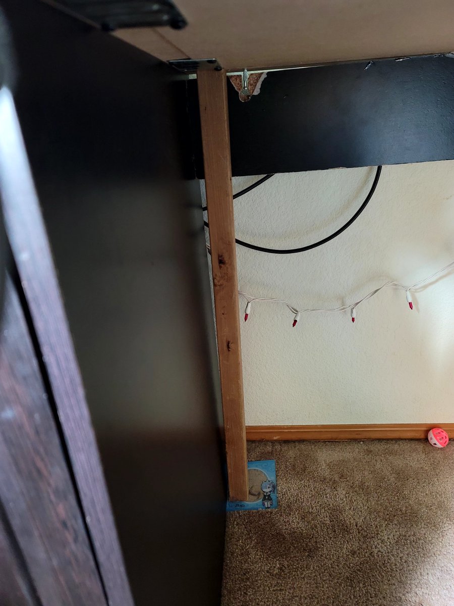 My desk is being held together by a stick and an anime girl