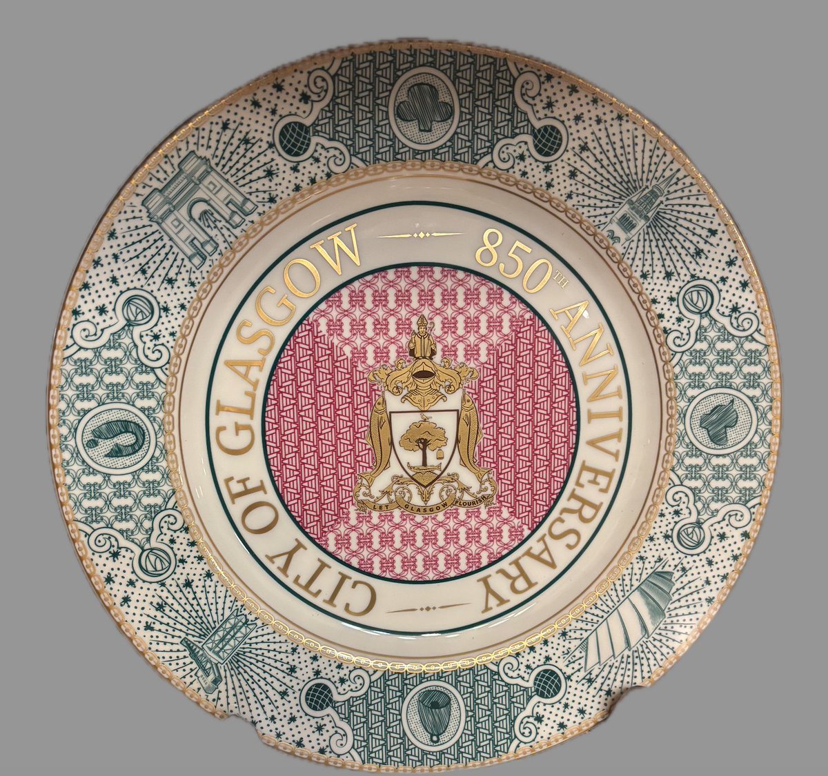 This plate was commissioned by the Lord provost of Glasgow to celebrate the 850th Anniversary of the City. It echoes a plate made in Bell’s Pottery factory in the late 1880’s and is layered with meaning, symbols and images representing Glasgow’s past and present. 
<a href="/GlasgowCoA/">Glasgow Coat of Arms</a>