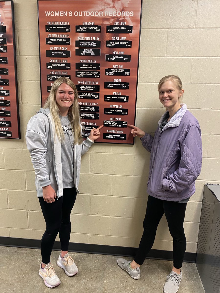 New Doane Track and Field  Hall of Fame Pole Vaulter, Megan Bauer, meets current NAIA National Champion Kaylee Pribyl. Here they are pointing at the record they share.