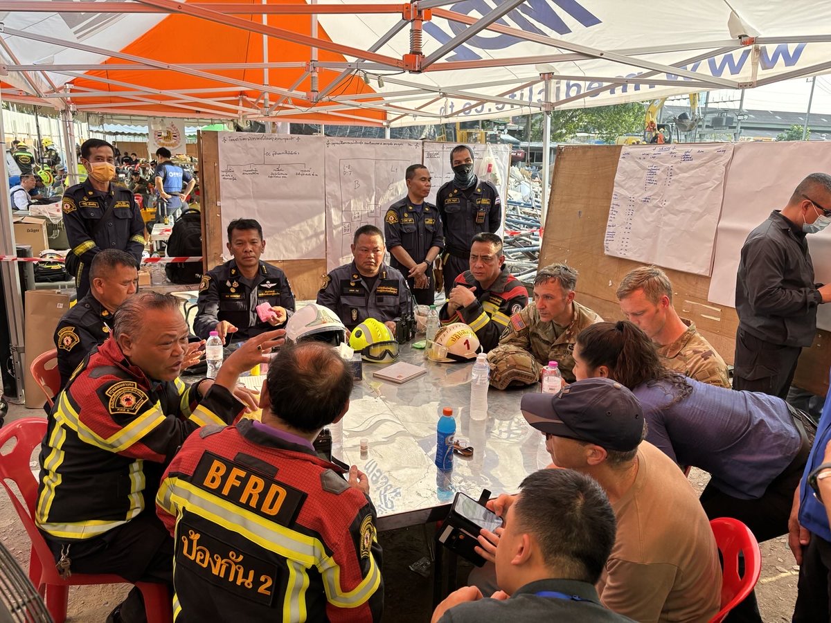 USPACOM's tweet photo. U.S. Military personnel from U.S. Indo-Pacific Command meet with first responders at the Search and Rescue Operations Center near the collapsed State Audit Office building in Bangkok, which fell after a 7.7 earthquake hit Thailand and its neighbor countries on March 28, 2025. https://t.co/CHwKZmpwmU