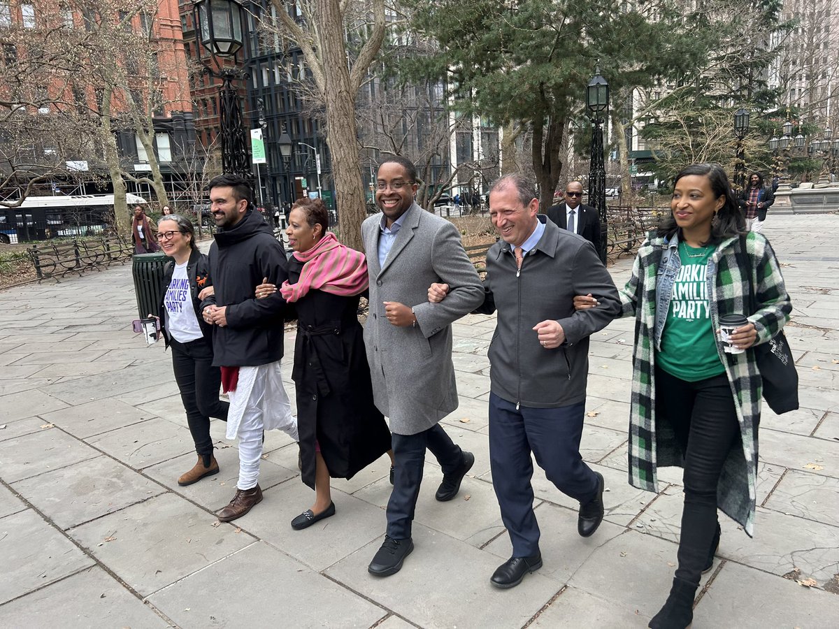 Mayoral candidates endorsed by the Working Families Party arrive arm in arm at City Hall presser