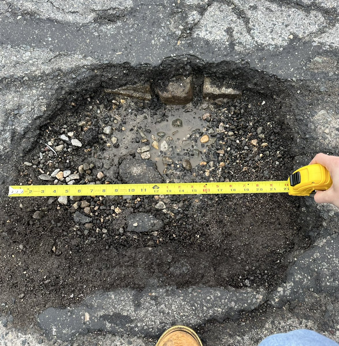 aselahcurtis's tweet photo. Having driven through the minefield of potholes that is Lowell city roadways, I’ve  decided to document some of the notable examples. In the photograph is a fine specimen on Broadway, between Suffolk and Lewis, measuring approximately 22” length, 19” width, 5” depth. https://t.co/ABYelB2lZp