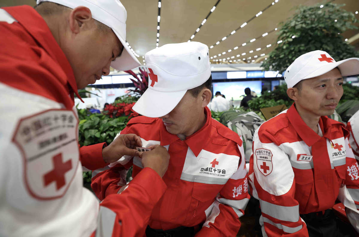 China_says's tweet photo. An international rescue team dispatched by the Red Cross Society of China stands ready at Kunming Changshui International Airport before departing for Myanmar on Sunday. (Photos courtesy of https://t.co/XQIPzf2AHR) https://t.co/pDvbs6BeNK