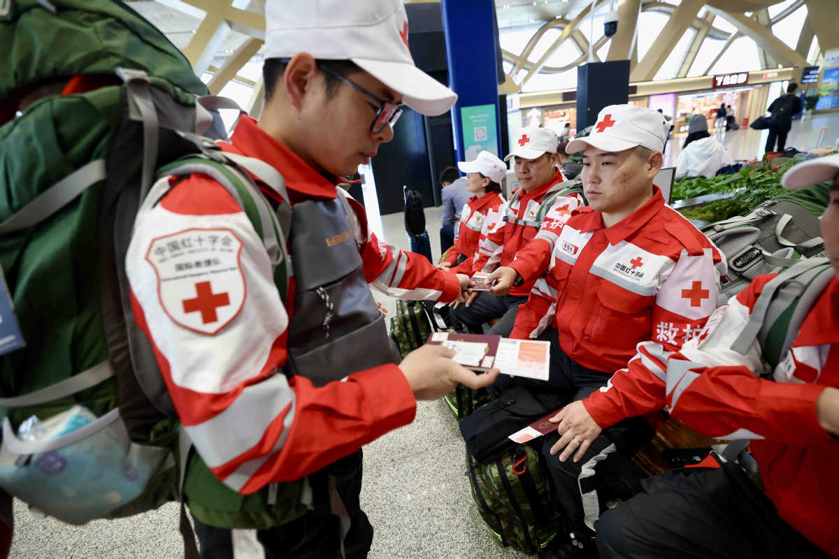 China_says's tweet photo. An international rescue team dispatched by the Red Cross Society of China stands ready at Kunming Changshui International Airport before departing for Myanmar on Sunday. (Photos courtesy of https://t.co/XQIPzf2AHR) https://t.co/pDvbs6BeNK