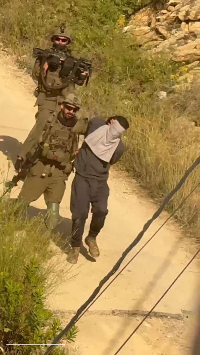 Israeli occupation soldiers savagely arrest a Palestinian youth during a raid into the town of Qabatiya, north of the occupied West Bank.