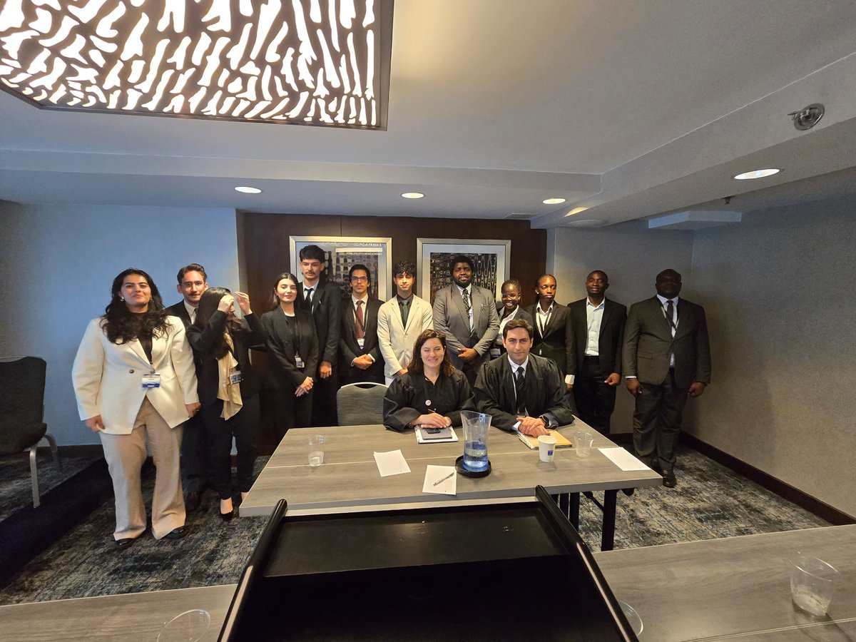 uculaw's tweet image. Preliminary Round 2: Team Uganda takes a photo with the Judges and Team 116 after the 2nd preliminary round as Respondent.