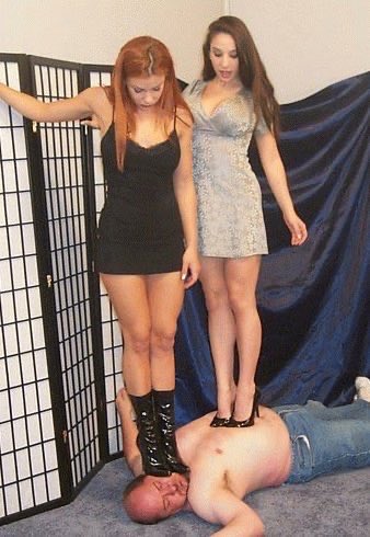 A great image from the legendary, but now defunct Trample.com. Two beautiful Ladies standing on an inferior male. I love how both are looking down at the slave, probably to see how much he is suffering under their sharp high heels.