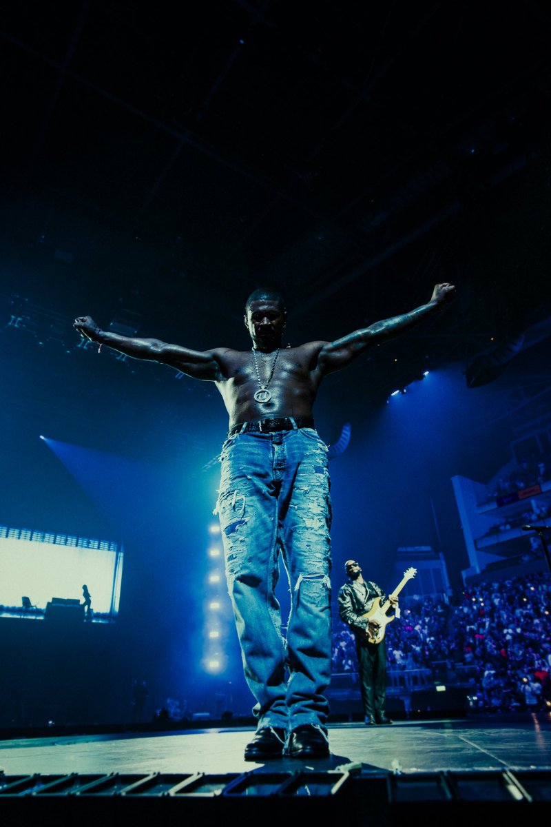 Usher's tweet photo. Brought the A to the UK!! London - it’s been too long, so I’m making up for lost time. I haven’t played London in 10 years so U know we had to do a show for each year we missed. 

Who else will I see at the O2 while I’m here? #PPFTour ⏪▶️⏩ https://t.co/iuSPFmMtq6