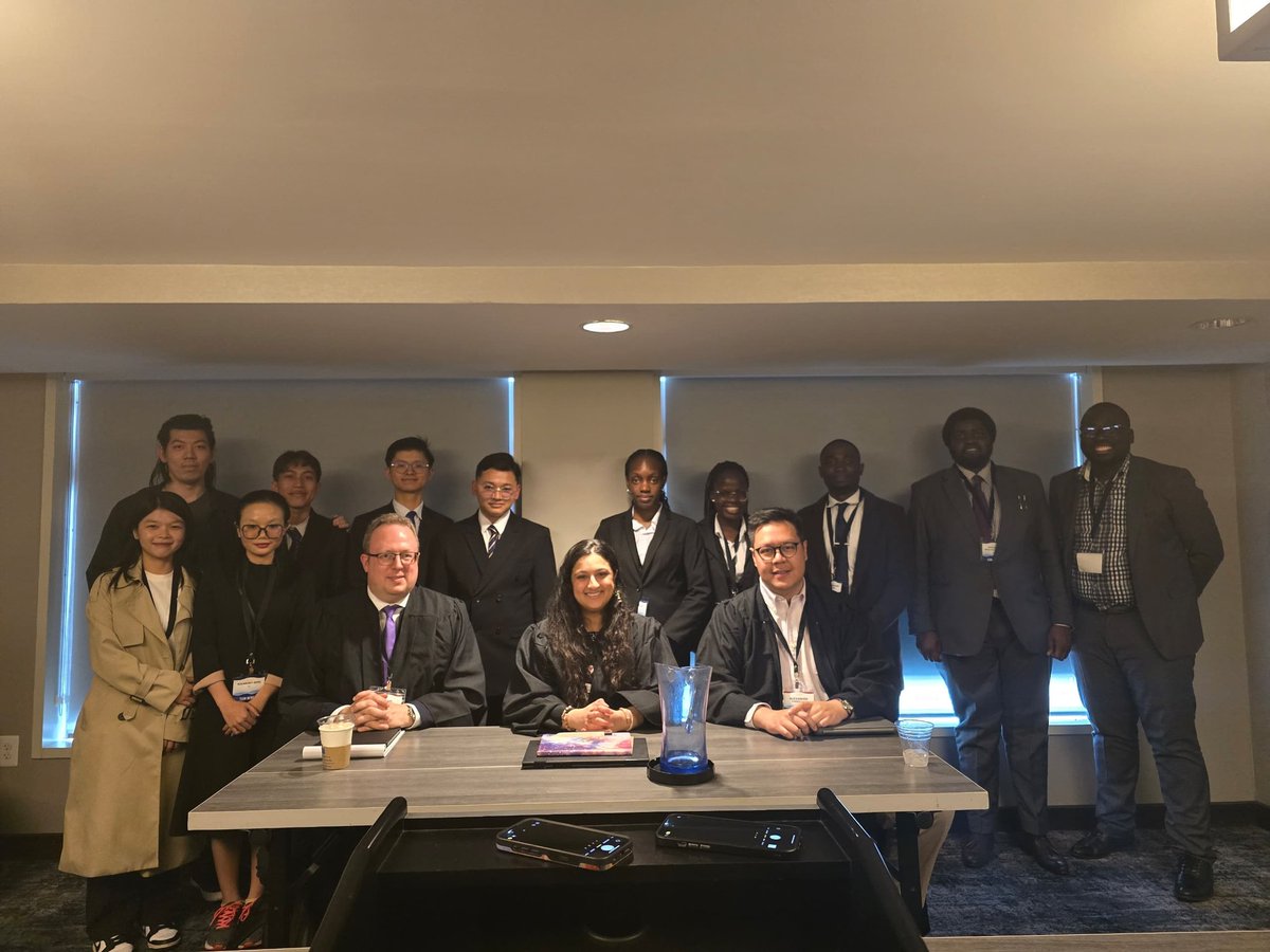 uculaw's tweet image. Preliminary Rounds 4: Team Uganda takes a photo with the Judges and Team 317 after the 4th preliminary round as Respondent at the JESSUP moot in the Washington D.C.