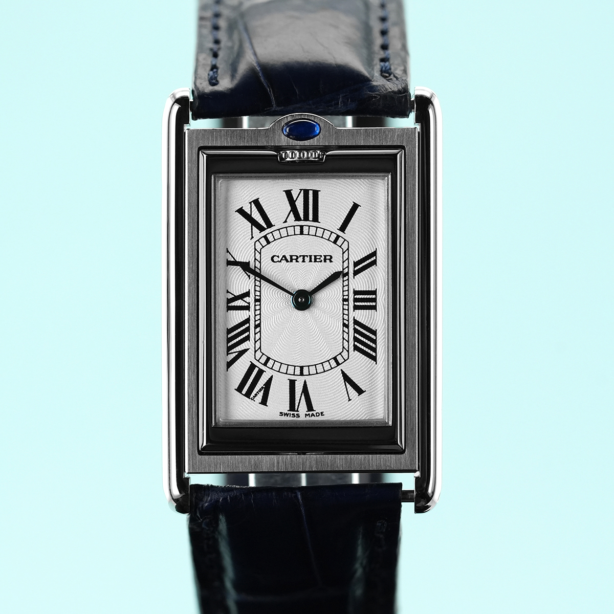 swcwatches's tweet photo. We are proud to present this timeless Cartier Tank Basculante for sale in mint condition.

The Cartier Tank Basculante, introduced in 1933, stands as a testament to Cartier's innovative approach to watchmaking during the Art Deco era. Designed to combine elegance with functionality, the Basculante was a clever response to the challenges of protecting a watch’s delicate crystal and dial. Its defining feature, a reversible case mounted on a pivoting frame, allowed wearers to flip the watch face inward, safeguarding it during rigorous activities. Inspired by the sporty practicality of the #Jaeger-LeCoultre Reverso but infused with Cartier's signature sophistication, the Tank Basculante became a symbol of timeless ingenuity. With its clean, geometric lines and understated allure, the Basculante remains an enduring icon in Cartier's Tank collection.

This iteration of the #Tank Basculante, reference W1011358 comes set in a polished 25.4 x 38.6 mm stainless steel case and is fitted with a blue alligator strap with matching deployment clasp. The silver Guilloche #dial features black printed roman numerals and blued steel sword hands. These details are protected by a flat sapphire crystal and powered by the manual wind calibre 060 MC movement which is protected by a closed brushed caseback. Lastly, its 3atm (30m/100ft) water resistance is ensured by a push/pull crown embellished with a blue spinel cabochon and located at 12 o'clock.

Originally sold in March 2005 and in mint condition for its age, supplied with its original inner box, instruction booklet, 2025 service documentation and its original international warranty card.

This #Cartier is sold with our 12-month warranty from the date of purchase, however is also covered by its 'Century Watch Repairs' service warranty until January 2027.