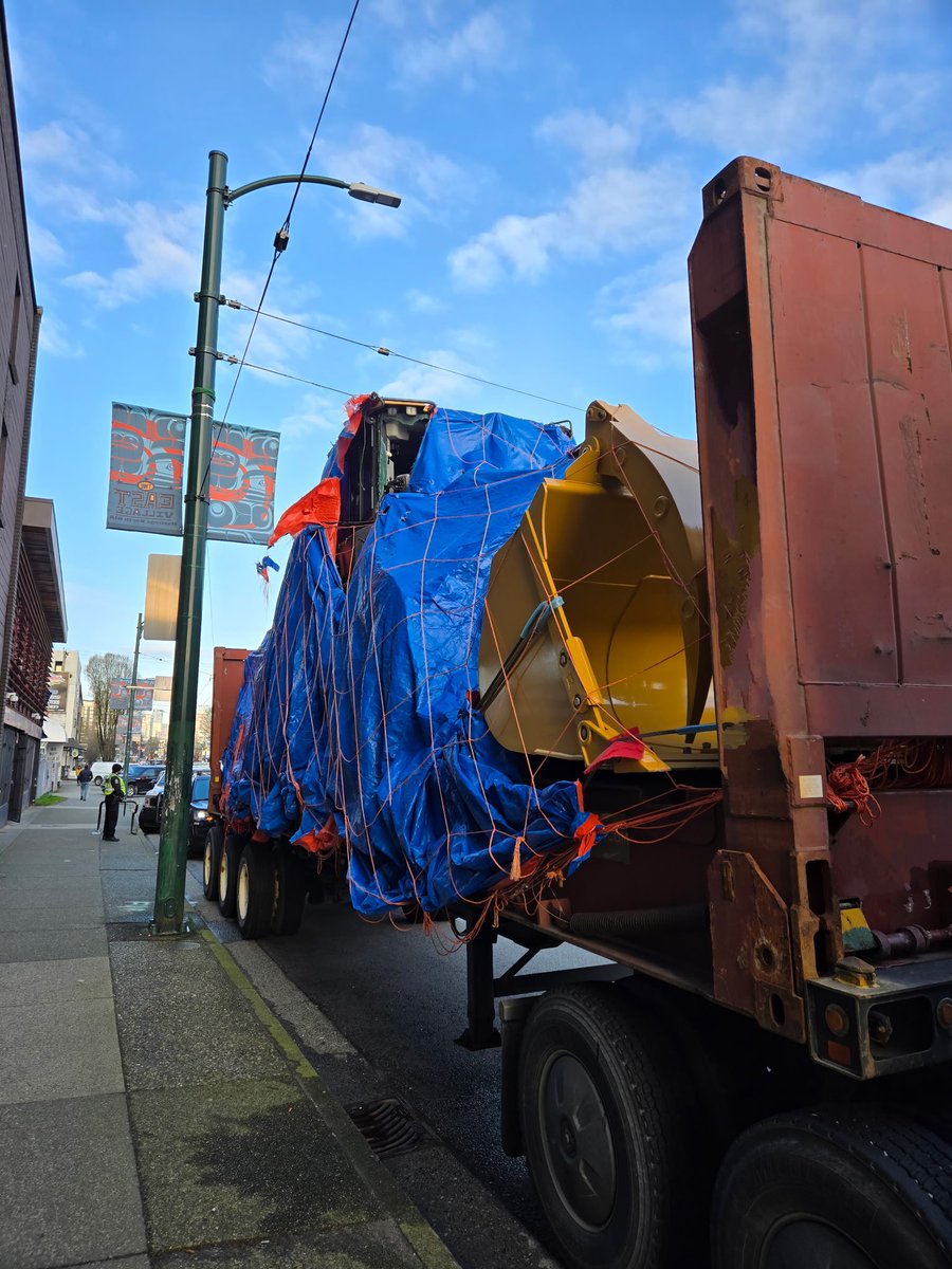 Around midnight, this individual drove from Clarke to almost Commercial on E. Hastings. Took out trolley lines along the way due to overheight load at 5.18m (max height is 4.15m). Still on scene waiting for crane to lift load and place on lower flat deck.