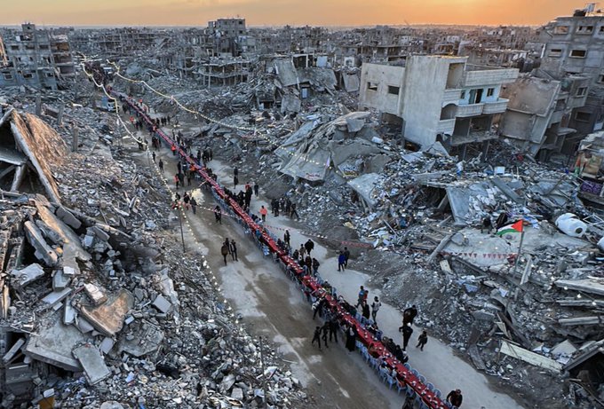 Photo of Palestinians during Ramadan surrounded by destroyed buildings. 