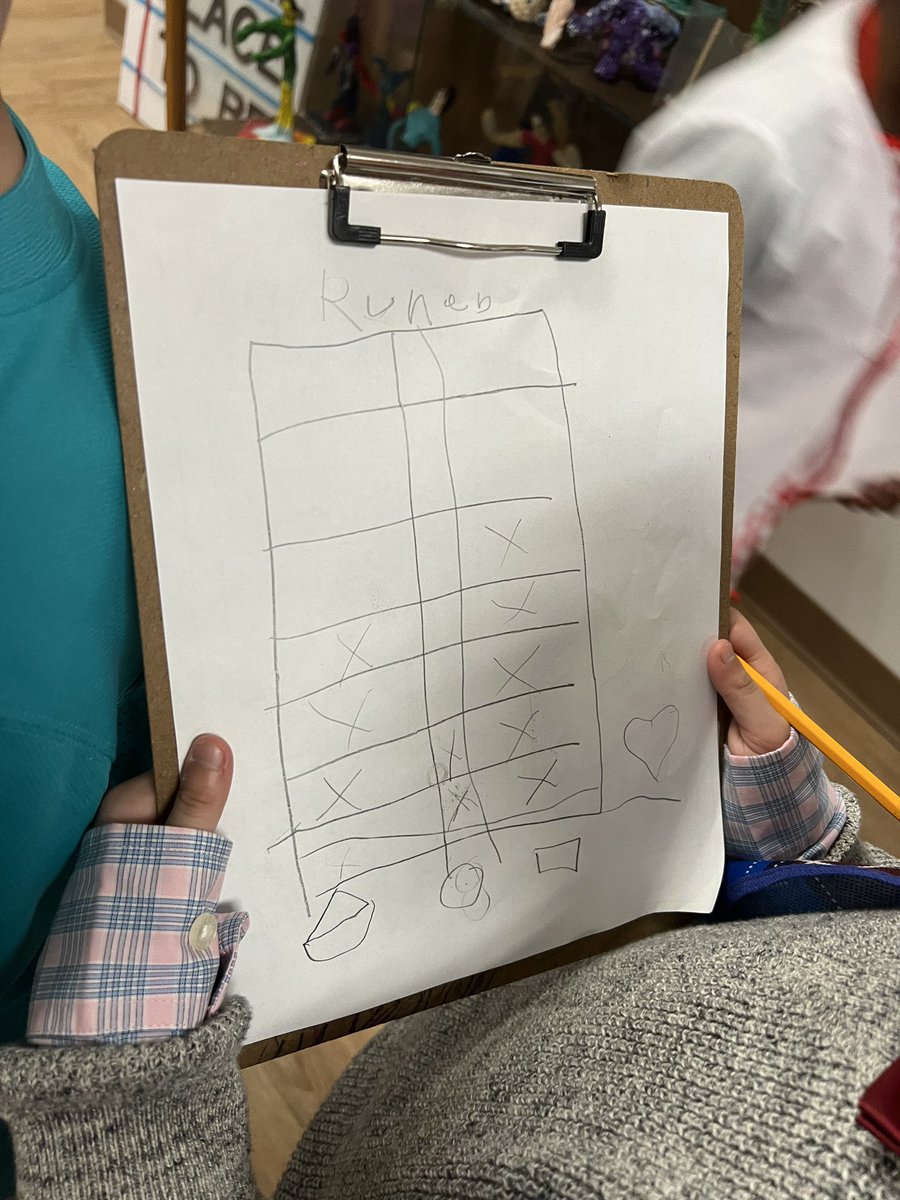 Kindergartners on a scavenger hunt to find 3D shapes around the building.
