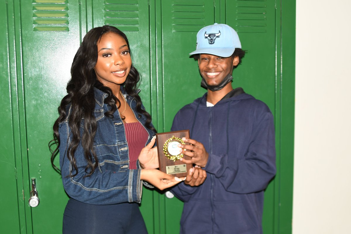 Junior Trinity Miles and senior Eric Nichols hold their trophy from the recent Chicago Debate League High School Policy: City Championship, which featured the topic of how artificial intelligence impacts copyright/property rights.