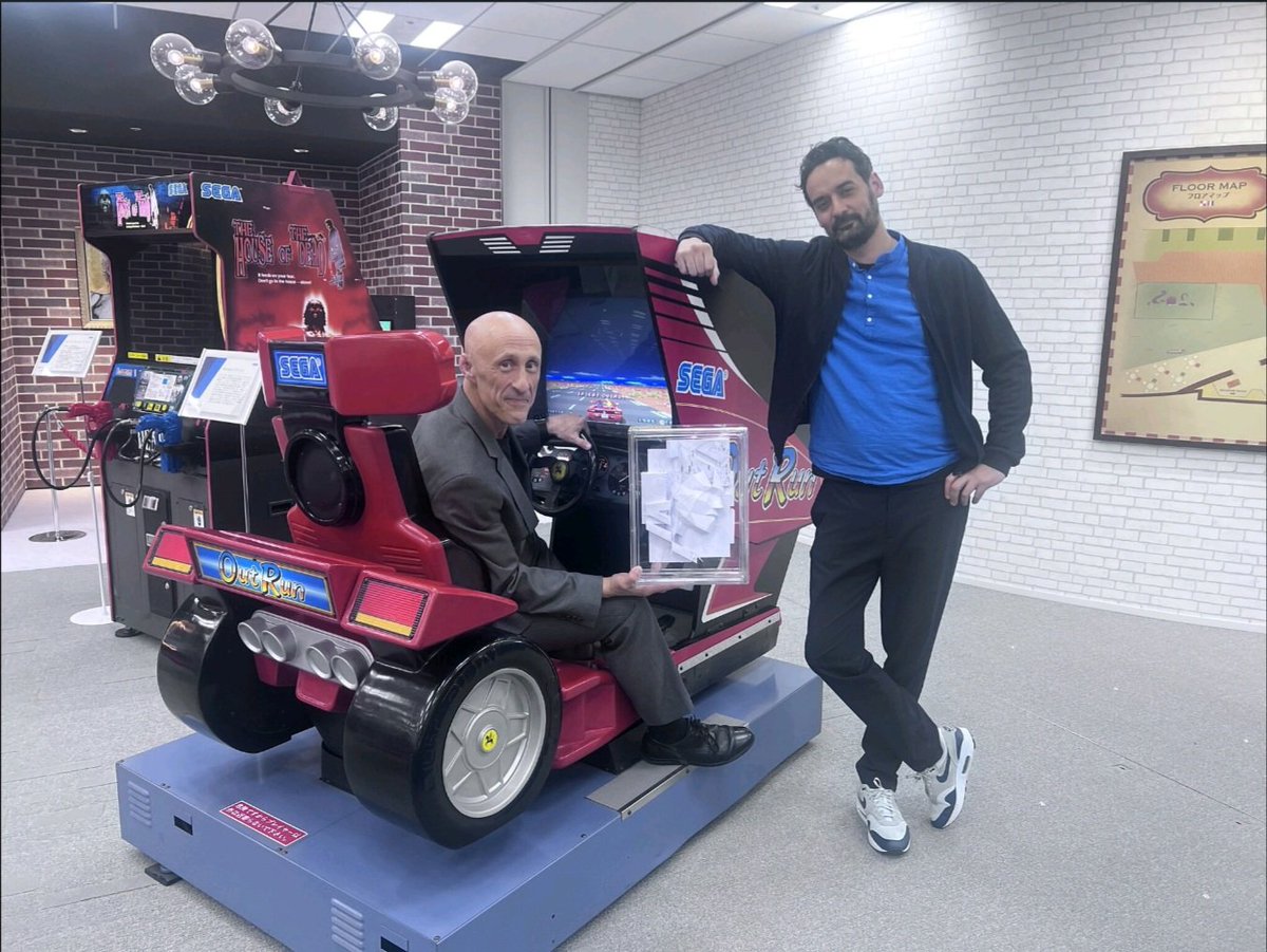 Yesterday, French Artist &amp; Humanitarian David Mesguich visited SEGA HQ and met with SEGA Executive Vice-President and Global Head Of Transmedia, Justin Scarpone.

Here's the two posing on a classic OutRun arcade cabinet at SEGA's Japan office.
