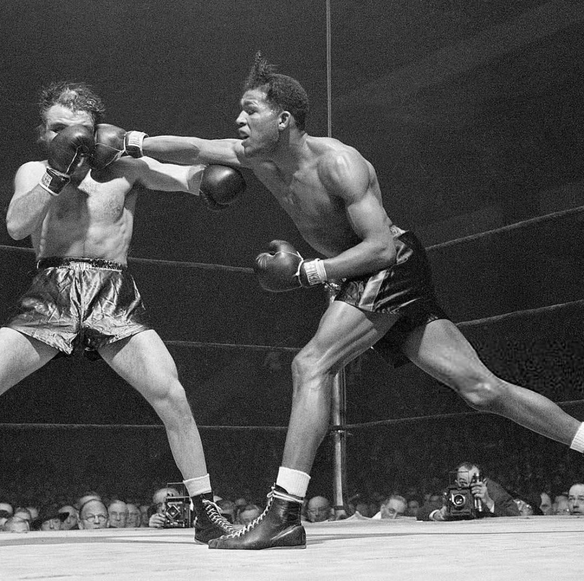 fighting_pod's tweet photo. Ray Robinson lands a long right on Jake LaMotta at Madison Square Garden, 1945. https://t.co/b95aqrFtNG