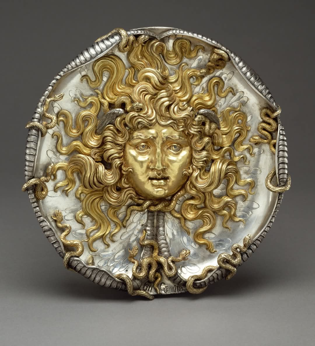 Medusa by Vincenzo Gemito (Italian, 1852-1929) :

The severed head of Medusa stares out from convex face of a two-sided relief. Its psychological realism, simultaneously beautiful and hideous, reveals the conflicting yet symbiotic emotions of attraction and repulsion. 

This combination expresses the power of ancient Greek apotropaic objects, charms that warded off evil. Since the sight of Medusa's face transformed by the goddess Athena into a monster with snakes for hair had turned men into stone, it became a traditional apotropaic symbol. Athena affixed the actual Medusa's monstrous head to her shield, and human warriors followed suit.

The sculptor Vincenzo Gemito derived his composition from the famous antique cameo, the Tazza Farnese, but transformed it into an entirely new kind of sculptural object. He revived Renaissance techniques of lost-wax casting to make the relief. Although he concentrated on the face of the two-sided, glistening metallic relief, he textured the back with snakeskin.

The Getty Villa Museum 

#archaeohistories