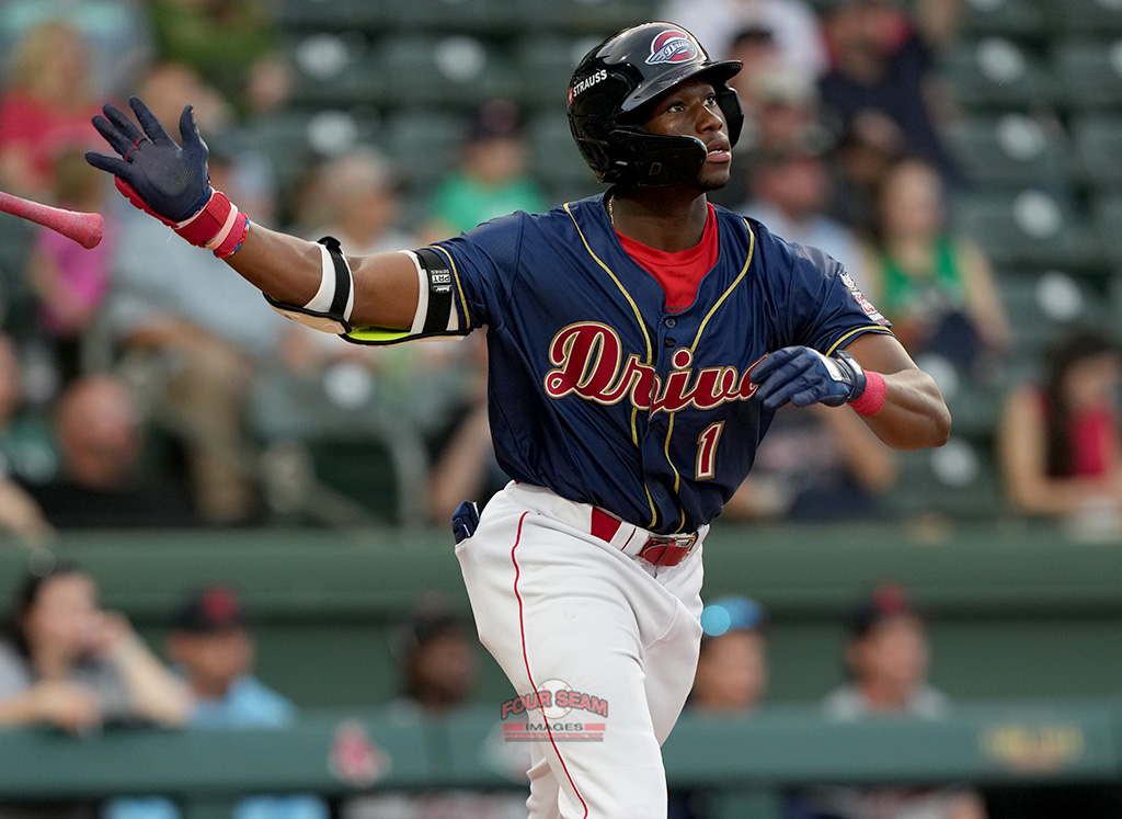 Nelly Taylor (1) of the Greenville Drive watches as his three-run home run, the team's first of the season, sails over the right field fence in a game against the Bowling Green Hot Rods on Friday, April 4, 2025, at Fluor Field in Greenville, S.C. (Tom Priddy/Four Seam Images)