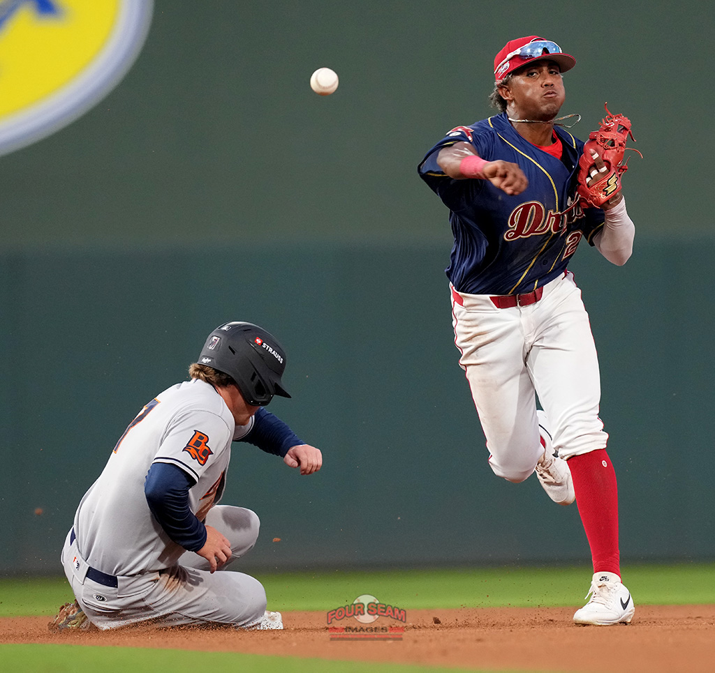 Emilien Pitre (7) of the Bowling Green Hot Rods is out at second as second baseman Marvin Alcantara (20) of the Greenville Drive turns a double play in a South Atlantic League game on Friday, April 4, 2025, at Fluor Field in Greenville, S.C. (Tom Priddy/Four Seam Images)