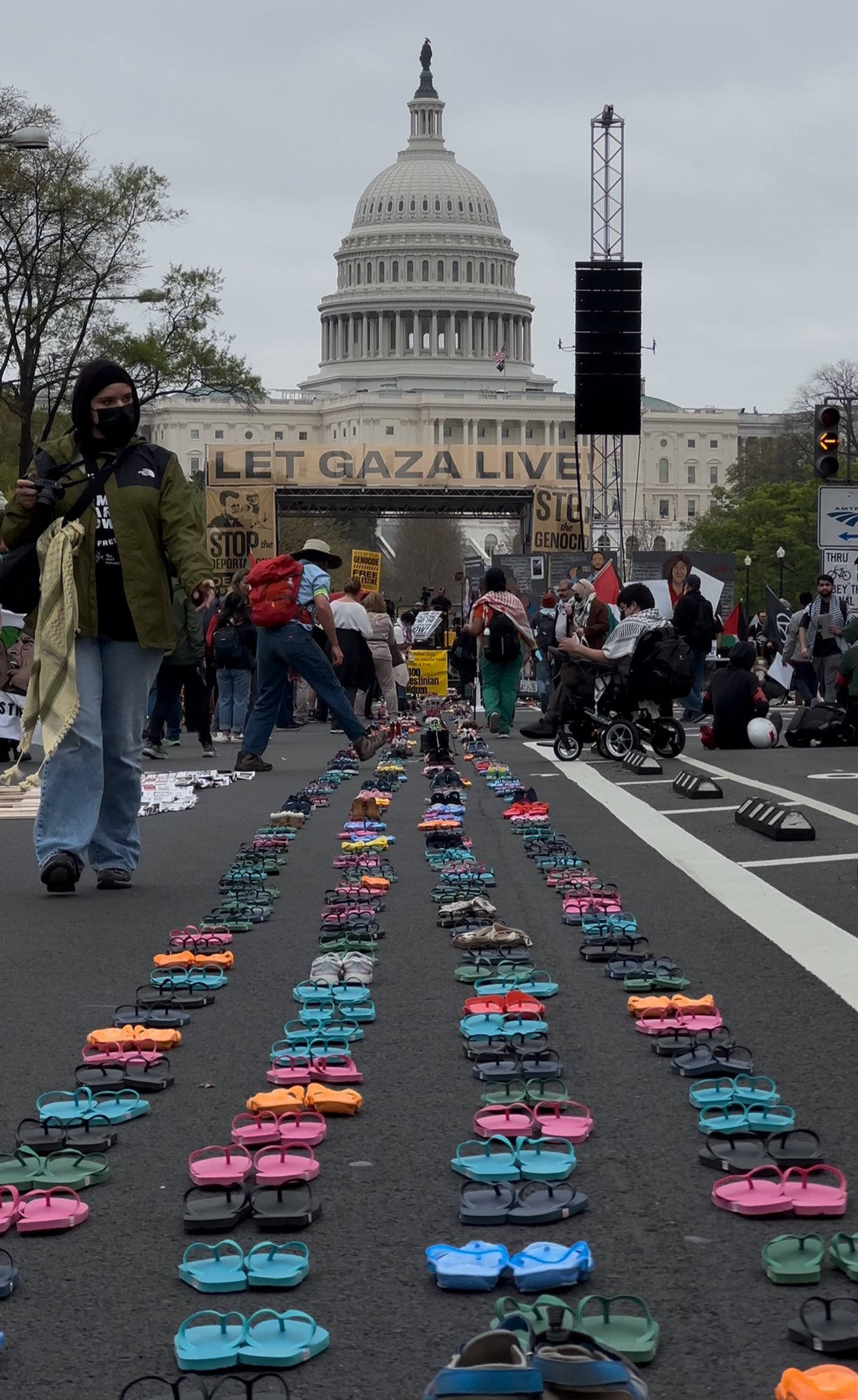 Thousands of children’s shoes are lined up the street in Washington, DC, representing the 17,400+ Palestinian children killed  by Israel