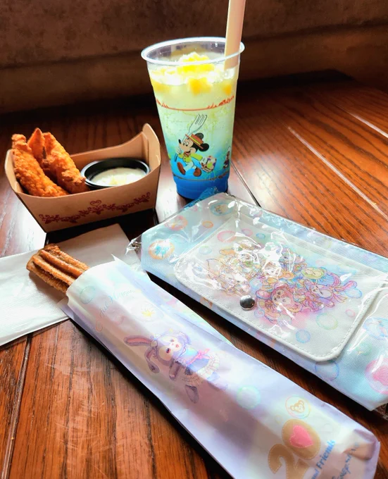 ザンビのパイナップル&amp;ココナッツのスパークリング(ノンアル) オリーブとヨーグルトディップのチキンテンダー スーベニア付きのチュロス(ミルクティー味) チュロスの袋はダフィフレ7人のランダム