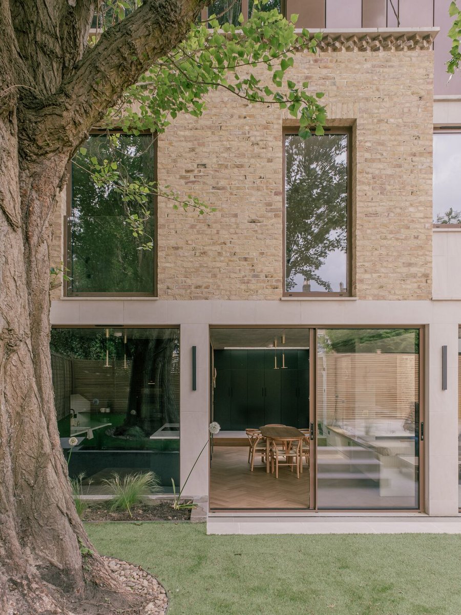 Archello's tweet image. On a tight Blackheath infill site, Mailen Design crafts a contextual yet contemporary home using reclaimed London stock brick, bronze-finished aluminium, and pre-cast stone.
buff.ly/8ytt9ld

#ContextualArchitecture #ReclaimedBrickwork #SustainableMaterials